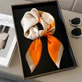 Nahaufnahme des Seidenschals mit Ginkgoblatt-Muster in elegantem Orange und Perlmuttweiß - Orangerot / 70x70cm