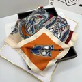 Detail of elegant paisley print silk scarf with orange and blue geometric patterns - Orange
