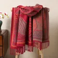 Close-up of thick winter shawl with retro wave patterns and elegant fringe details - Dark Red