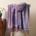 Close-up detail of double-sided knit shawl showing purple leaf patterns and fringe tassels - Dark Violet
