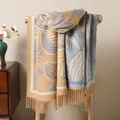 Close-up of thick winter shawl featuring blue leaf jacquard patterns and long tassels - Khaki