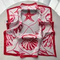 Detail of red starfish and seashell print on a lightweight white square silk scarf - Red