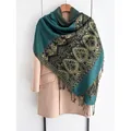 Ethnic style pashmina shawl in turquoise and gold with fringe on pink wool coat - Green