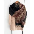 Ethnic paisley shawl in red and black with tassel detail on a beige coat - Black
