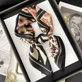 Elegant leopard print faux silk scarf with black geometric border on a stylish magazine - Black