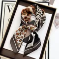 Elegant leopard print square silk scarf with geometric patterns in a luxury tray setting - Coffee