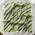 Close-up of green and purple striped silk square scarf with premium stitched edges - Light Green