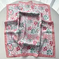 Detailed macro view of the premium satin silk square scarf with French vintage illustrations - Pink