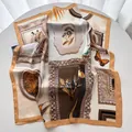 Detail of elegant satin scarf showing vintage butterfly and zebra print on smooth fabric - Caramel color
