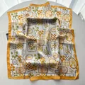 Detailed texture of square silk scarf featuring palm trees and sardine motifs with yellow edges - Yellow
