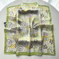 Detail view of the elegant silk-like square scarf featuring sea life and palm tree prints - Green