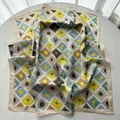 Detail of botanical print silk square scarf with summer stamp motifs and palm tree patterns - Khaki