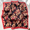 Detail of artistic floral pattern on square silk scarf with elegant red border trim - Red