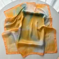 Elegant square silk scarf with vibrant orange, yellow, and blue tie-dye watercolor patterns - Gold