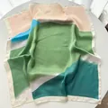 Close-up of lightweight silk square scarf featuring colorful abstract landscape patterns - 65cm x 65cm / Light Green