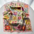 Detailed close-up of oil painting floral silk scarf with pink borders on white surface - Pink