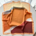 Detailed macro view of satin silk square scarf showing color block patterns and texture - 65cm x 65cm / Orange Red
