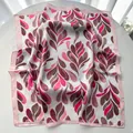 Detail view of satin silk square scarf with pink abstract leaf print and hemmed edges - Pink