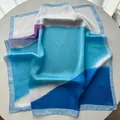 Detailed close-up showing abstract color block patterns and silk sheen of the square scarf - 65cm x 65cm / Sky Blue