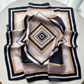 Striped color-block square silk scarf with geometric diamond pattern on a white table - Black