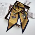 Detail of vintage geometric silk scarf with letter print on a premium display tray - Gold