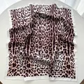 Detailed view of the leopard print silk square scarf showing fabric texture and satin edges - White