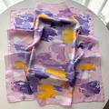 Detailed macro view of French style striped floral silk scarf with smooth satin texture - Violet