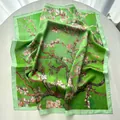 Macro shot of green floral silk scarf with almond blossom patterns and fine hem detail - Light Green