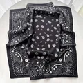 Detail of silk-like satin square scarf featuring black and white paisley floral pattern - Black
