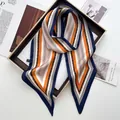 Detailed macro view of orange and navy striped silk scarf with elegant geometric patterns - Orange Red