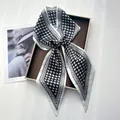 Detail of a black and white houndstooth silk scarf tied in a bow on a display box - Houndstooth Geometric Texture Satin Style (Style 18)