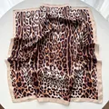 Detailed view of leopard print satin square scarf showing soft texture and silk sheen - Khaki