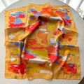 Macro view of luxurious yellow square silk scarf with multi-color abstract art splash pattern - Earthy Yellow