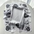 Detail of floral printed silk scarf with elegant black hand-drawn flowers on white fabric - Black
