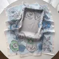 Detailed close-up of floral silk scarf with soft hand-rolled edges and elegant prints - White