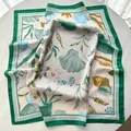 Square silk scarf with green border featuring seashells and purple floral print pattern - Green