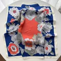 Detailed view of large floral print silk scarf with vibrant blue and orange color blocking - Blue