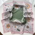 Detailed close-up of retro floral silk scarf with soft pink edges and satin texture - Pink