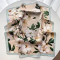 Detail view of floral satin square scarf with elegant blossom print and mint green border - Light Green