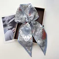 Detail showing paisley print satin scarf in grey-blue and orange tied in a bow - Light Blue Patchwork Paisley (Style 1)