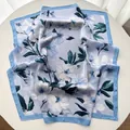 Elegant light blue floral silk scarf with large white flowers and a blue border - Sky Blue
