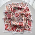 Silk-like square scarf featuring red and orange paisley prints on white base - Red