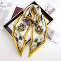 Detail of luxury satin scarf with vintage crown print and horse motif on brown tray - Lemon Yellow