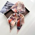 Close-up of artistic oil painting silk scarf tied in a bow on a display tray - Oil Painting Landscape Red Sailboat Art Style (Style 15)