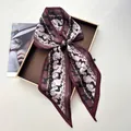 Detailed close-up of a burgundy silk twilly scarf with equestrian horse and chain patterns - Burgundy Base Black Horse Gold Chain (Style 7)