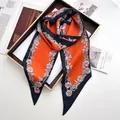 Floral print satin neck scarf in orange and black tones on a stylish golden tray - Orange Red
