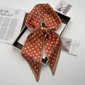 Close-up of elegant brick red silk scarf with white polka dots and pink floral prints - Chocolate