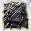 Elegant black silk square scarf featuring gold chain and belt print in a vintage style - Black