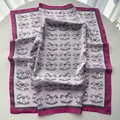 Pink satin square scarf featuring playful rocking horse prints and magenta borders - Pink