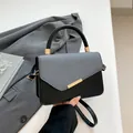 Minimalist linen patchwork handbag in black and gray with elegant gold hardware detail - Black